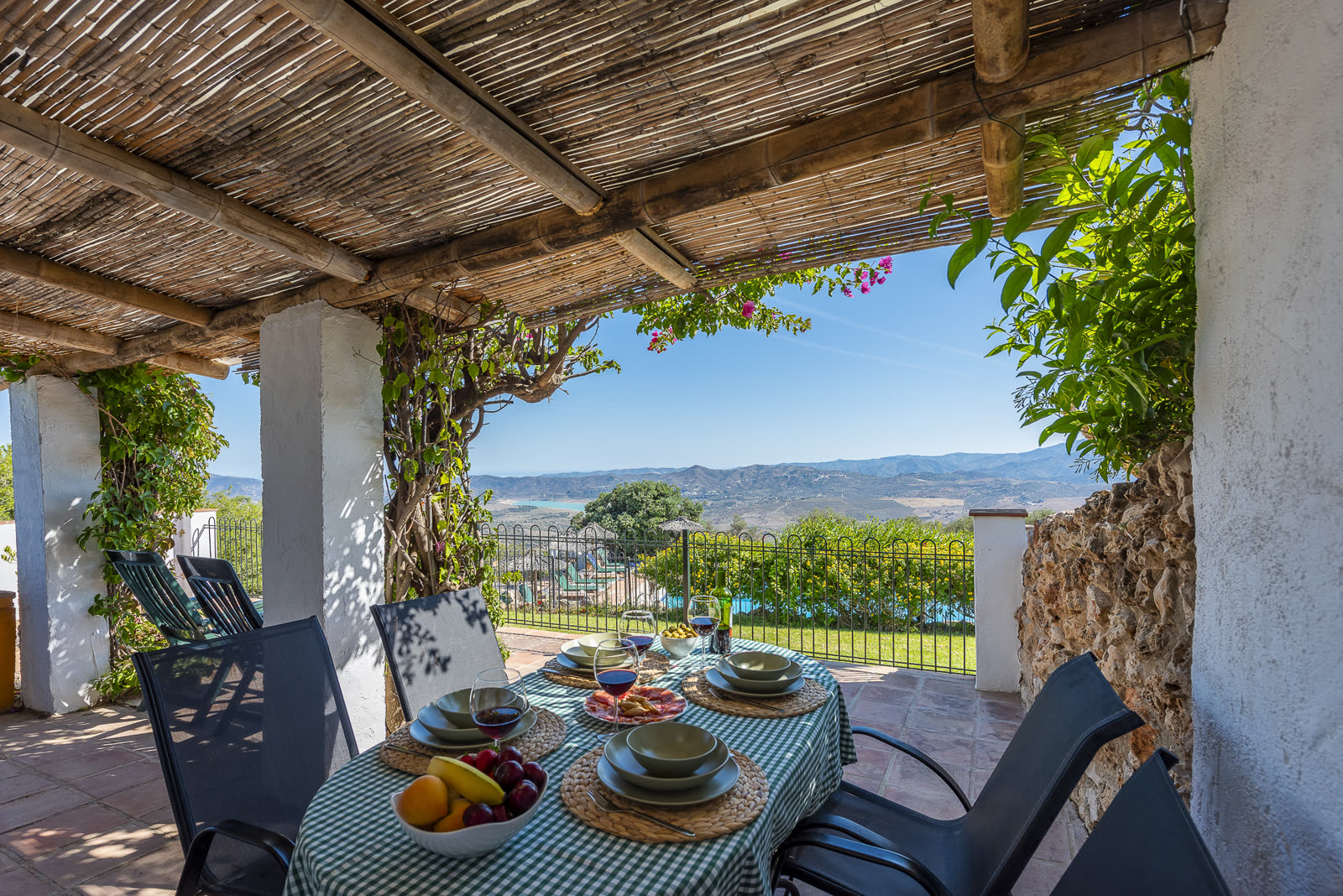 Table set for lunch on the covered terrace with valley views