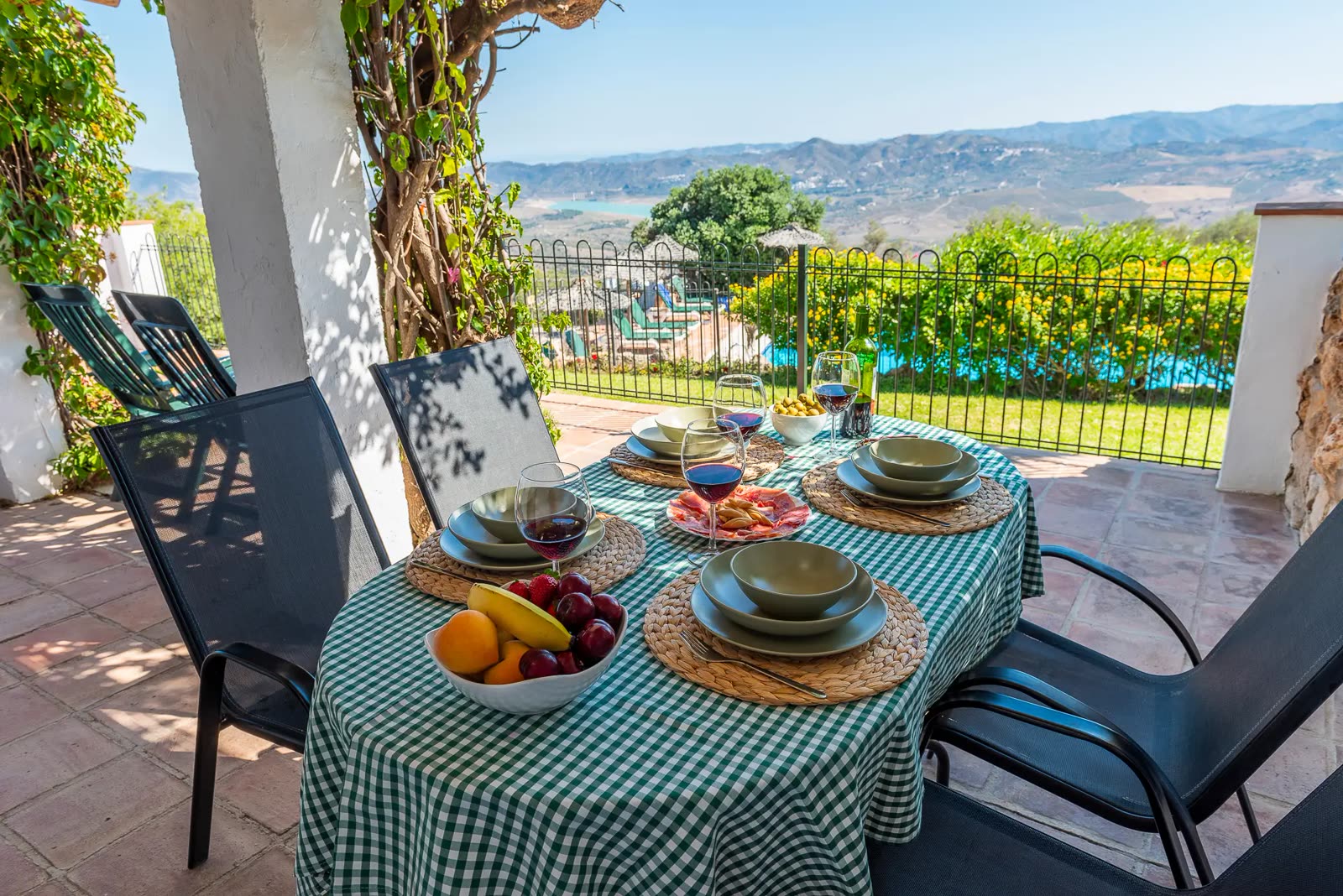 Terrace table set for lunch overlooking the pool and valley
