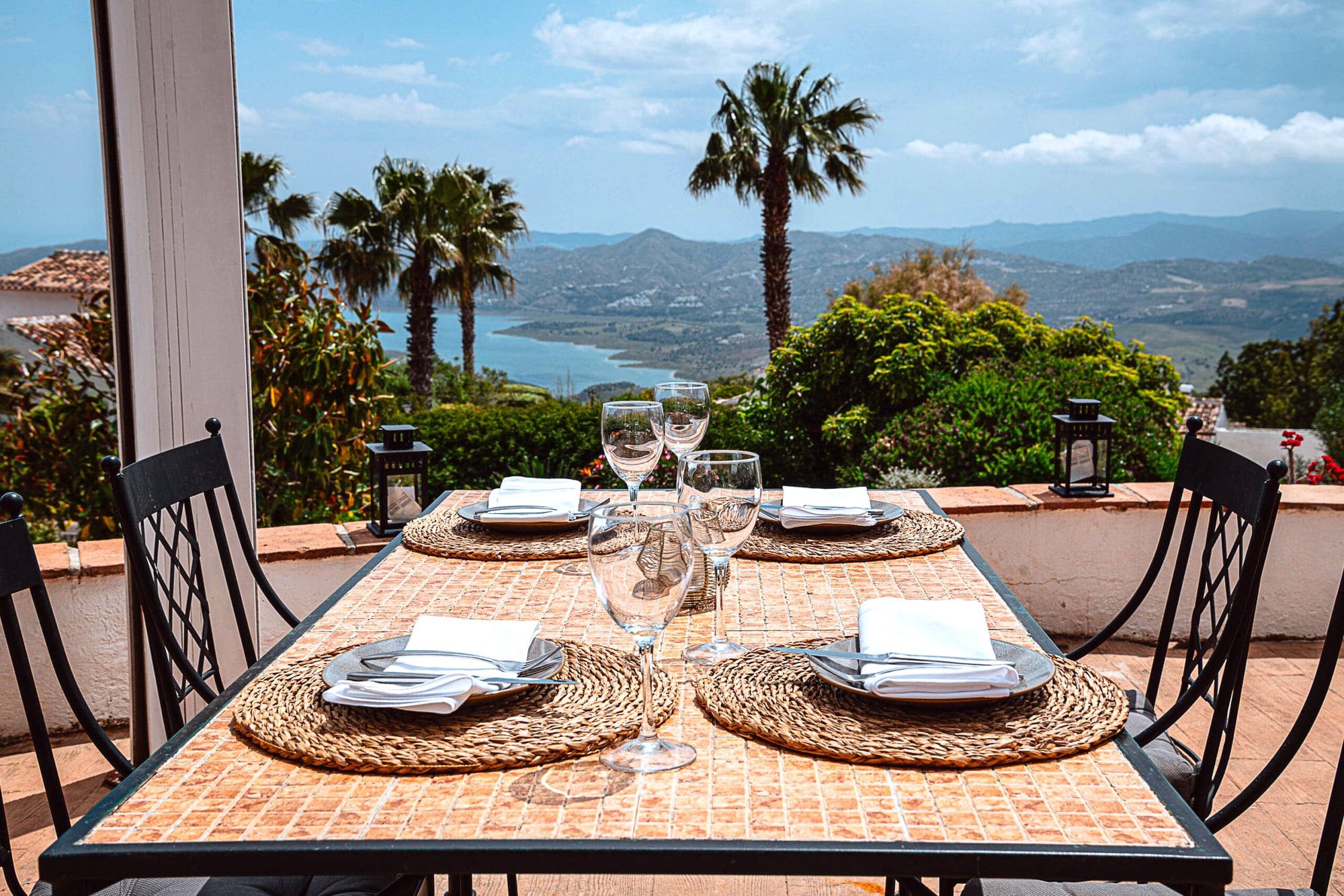 Table laid on the terrace overlooking Lake Viñuela