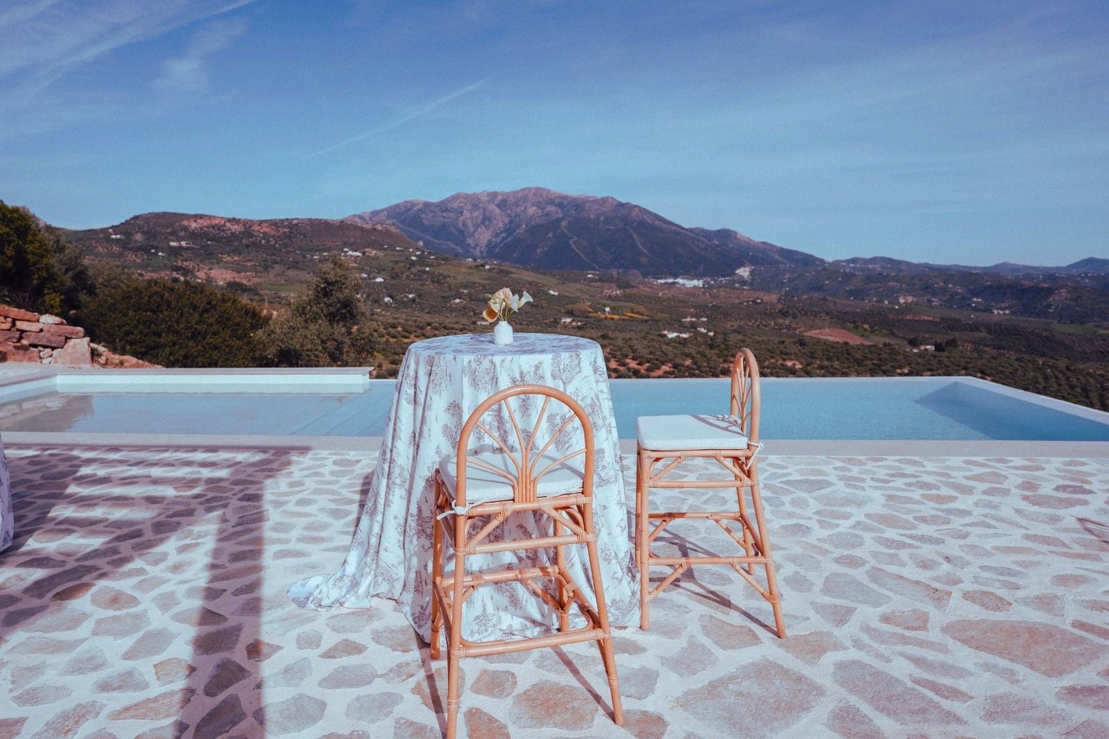 Pool terrace with loungers and far-reaching valley views